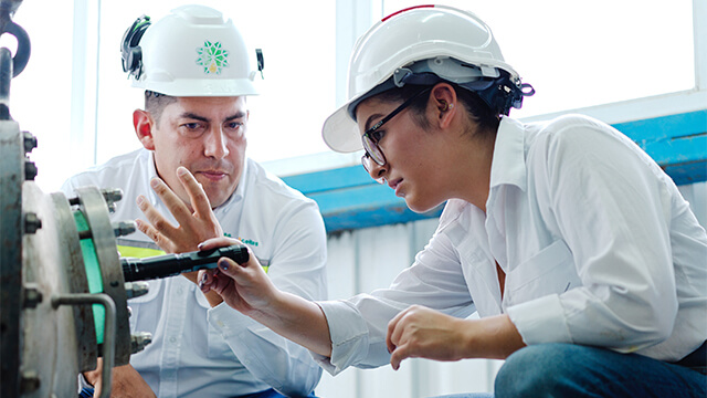 two men at Naturaceites palm oil refinery