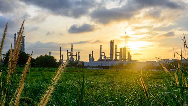 oil-refinery-green-grass-plants-sunset.jpg